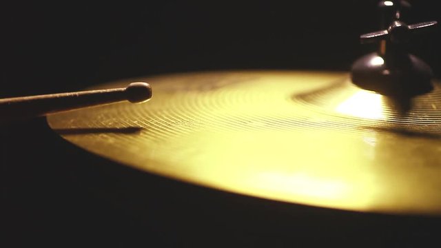 Close up footage of a drum stick hitting a cymbal.