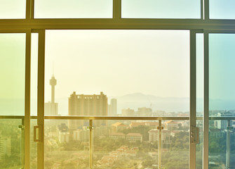 View of window and  high building at sunset