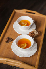 Herb tea with spice and lemon for two person. Selective focus
