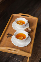 Herb tea with spice and lemon for two person. Selective focus