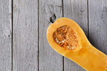 Pumpkin cut half top view on rustic wood background