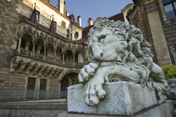 Stone statue of lion in entrance portal of the old castle in Moszna, near Opole, Silesia, Poland