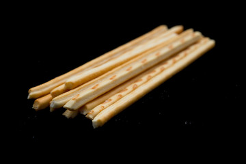 side view pretzel sticks on a black background