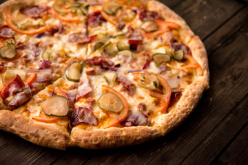 delicious pizza on thin crust with chicken, cheese, pickles and peppers