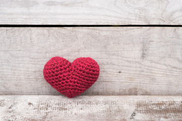Crocheted heart on a grunge background