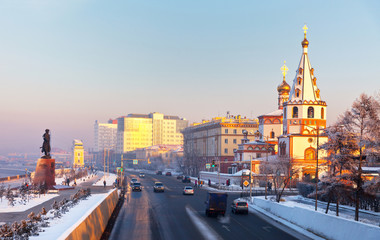 Siberia. Irkutsk. The view from the pedestrian bridge to the Cathedral of the Epiphany, monument to the Founder of the city and the Lower Embankment of Angara River at winter evening