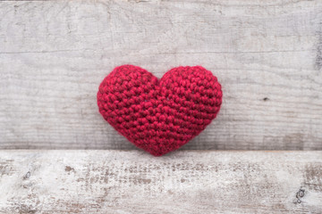 Crocheted heart on a grunge background