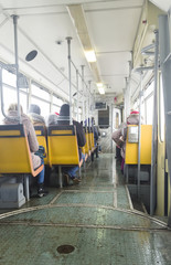 old tram interior with people in the city