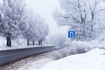 Winter trip road with road sign.