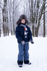 Fototapeta na wymiar The boy is happy playing in the snow