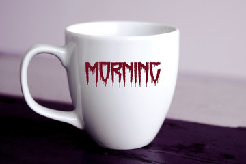 cup with the word Morning written in bloody letters