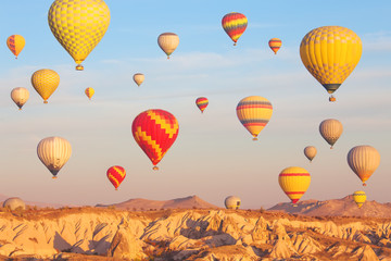 Fototapeta premium Scenic vibrant view of balloons flight in Cappadocia valley in s