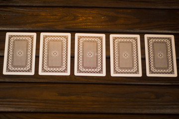 playing cards for poker the reverse side up on a dark wooden bac