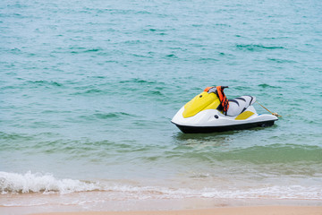 yellow and white Jet ski floating on blue sea,Tropical Ocean, pa