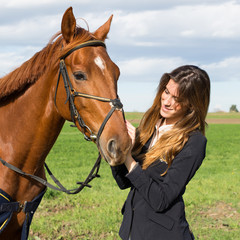 Obraz premium Beautiful young girl with her horse dressing uniform competition: outdoors portrait on sunny day