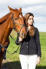 Fototapeta premium Beautiful girl with her horse dressing uniform competition: outdoors portrait on sunny day