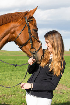 Beautiful young girl smile at her horse dressing uniform competition: outdoors portrait on sunny day