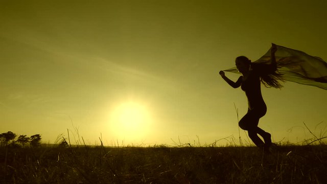 silhouette of  jumping girl against sunset