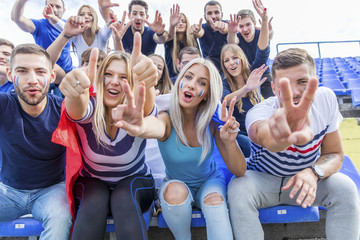 Group of soccer fans cheering and shouting