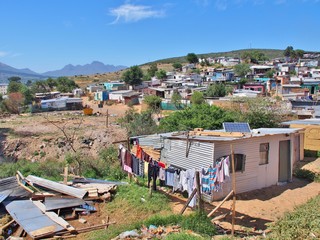 Informal settlement - Enkanini with mountain and blue sky on the outskirts of Stellenbosch, Western...