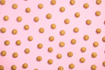 Pattern of sweet cookies on pink background