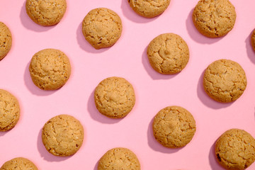 Pattern of sweet cookies on pink background