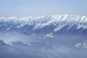 Naklejka premium Winter landscape over the Piatra Craiului Mountains in Brasov co