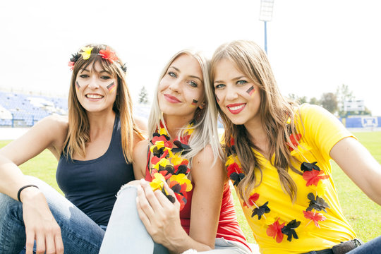 Portrait of three female soccer fans