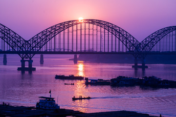 Yadanarbon bridge at sunset over Ayeyarwady River