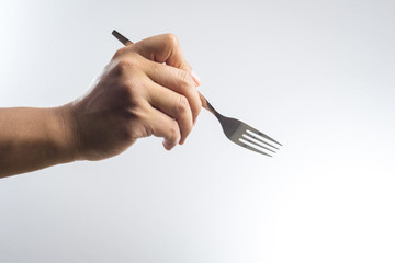Man hand holding a silver fork