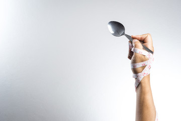 Man hand holding a silver fork and spoon