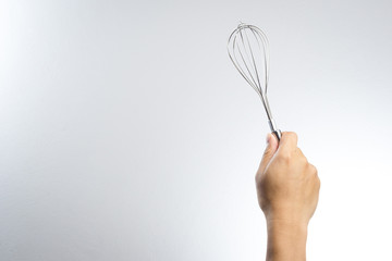 Hand holding stainless balloon whisk