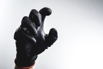 A hand wearing black glove - Powered by Adobe