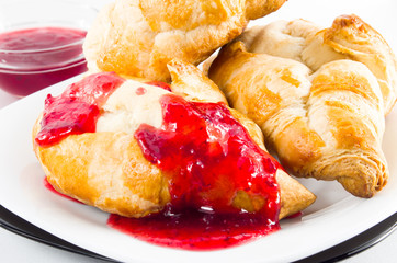 Several croissants with strawberry jam