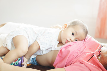 A year old Asian baby Breastfeeding