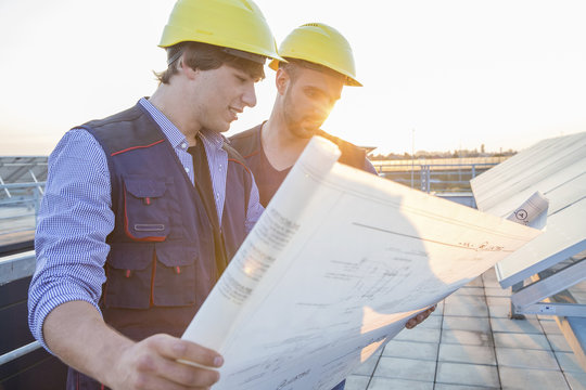 Architect and engineer inspecting solar power station