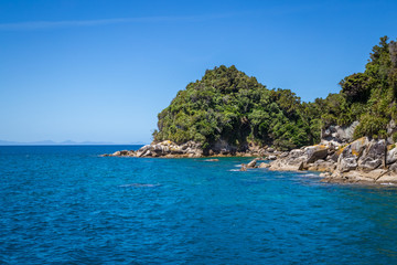 Coastal landscape with blue turquoise ocean water and rocks. 
