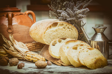Slices of bread. Composition with bread, flour, corn and other ingredients. Vintage filter applied. © EurekA_89 Gervasio S