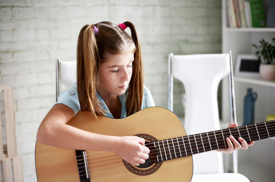 Girl learns to play guitar