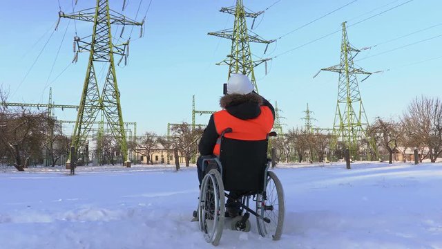 Disabled worker take pictures near to high-voltage lines