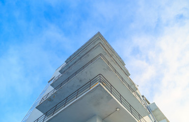 Office building with balconies on a background of blue sky