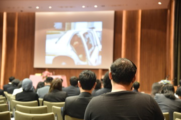 Fototapeta premium Blurred image of education people and business people sitting in conference room for profession seminar and the speaker is presenting new technology and idea sharing with the content activity.