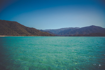 Plakat Beautiful dreamy ocean landscape with soft green hills of Abel Tasman National Park, New Zealand