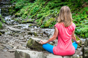 Woman meditating in the forest