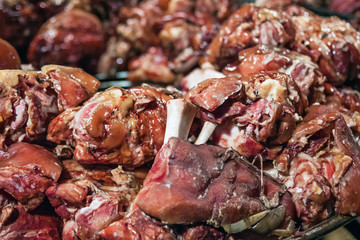 Street food. Pork knuckle cooked on the fire, outside on the Christmas market in Budapest.