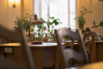 Reading at the table with a lamp in the library