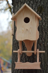 Wooden feeder handmade hanging in the park.