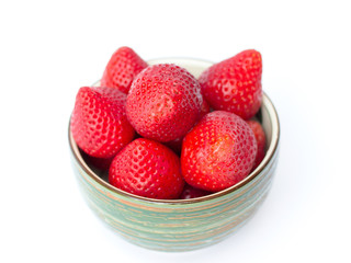 Fresh strawberries in a bowl on a white background