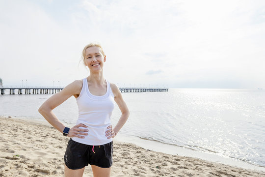 Woman in sports clothing on beach