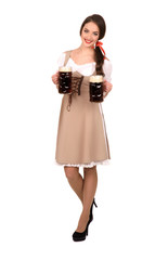 young sexy woman wearing a dirndl with two beer mugs isolate
